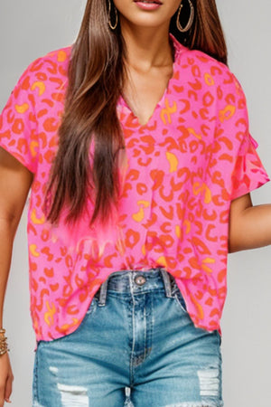 Hot pink leopard print blouse with flutter sleeves and V-neck.