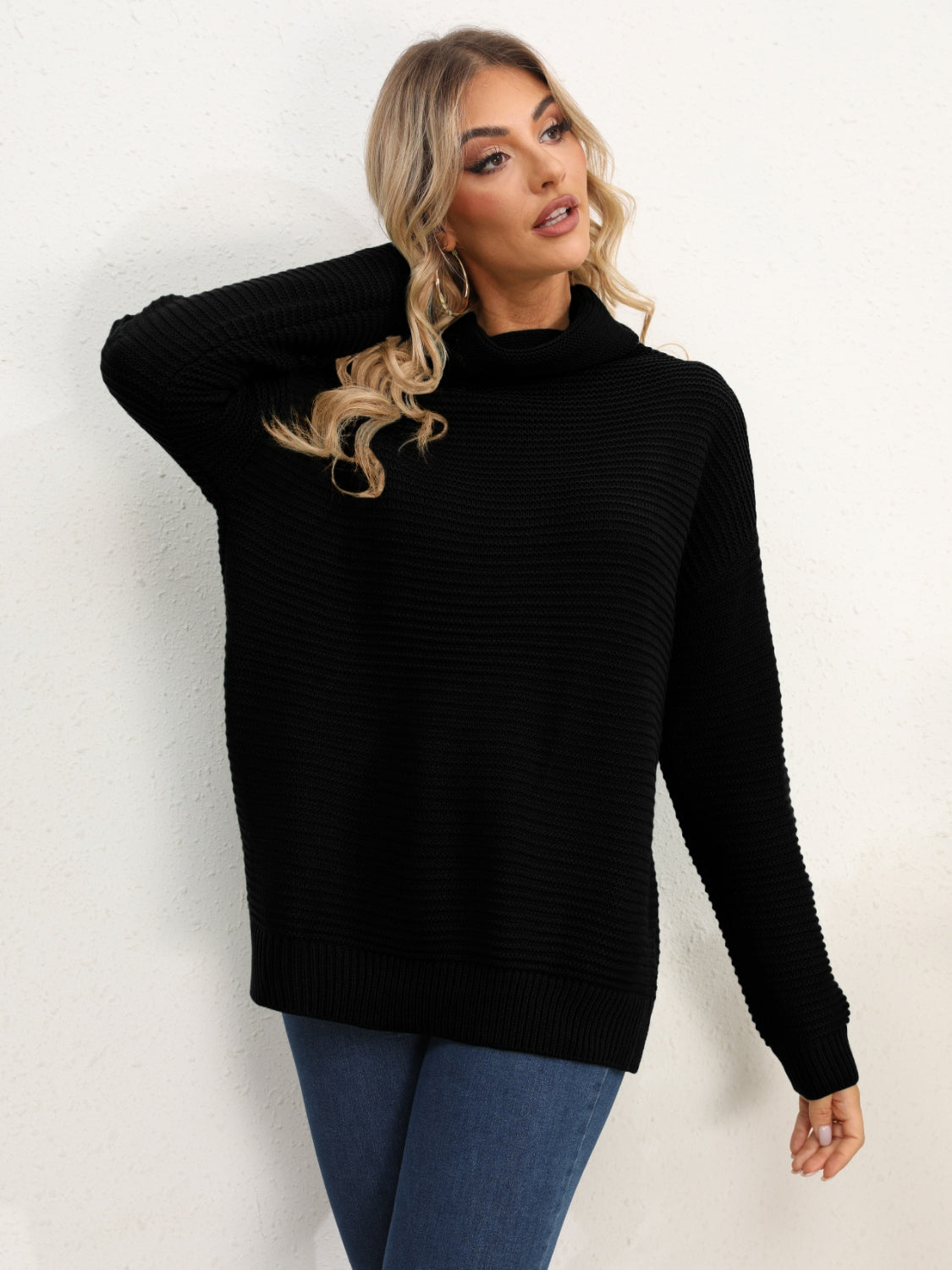 Black textured knit oversized turtleneck pullover sweater with a relaxed fit.