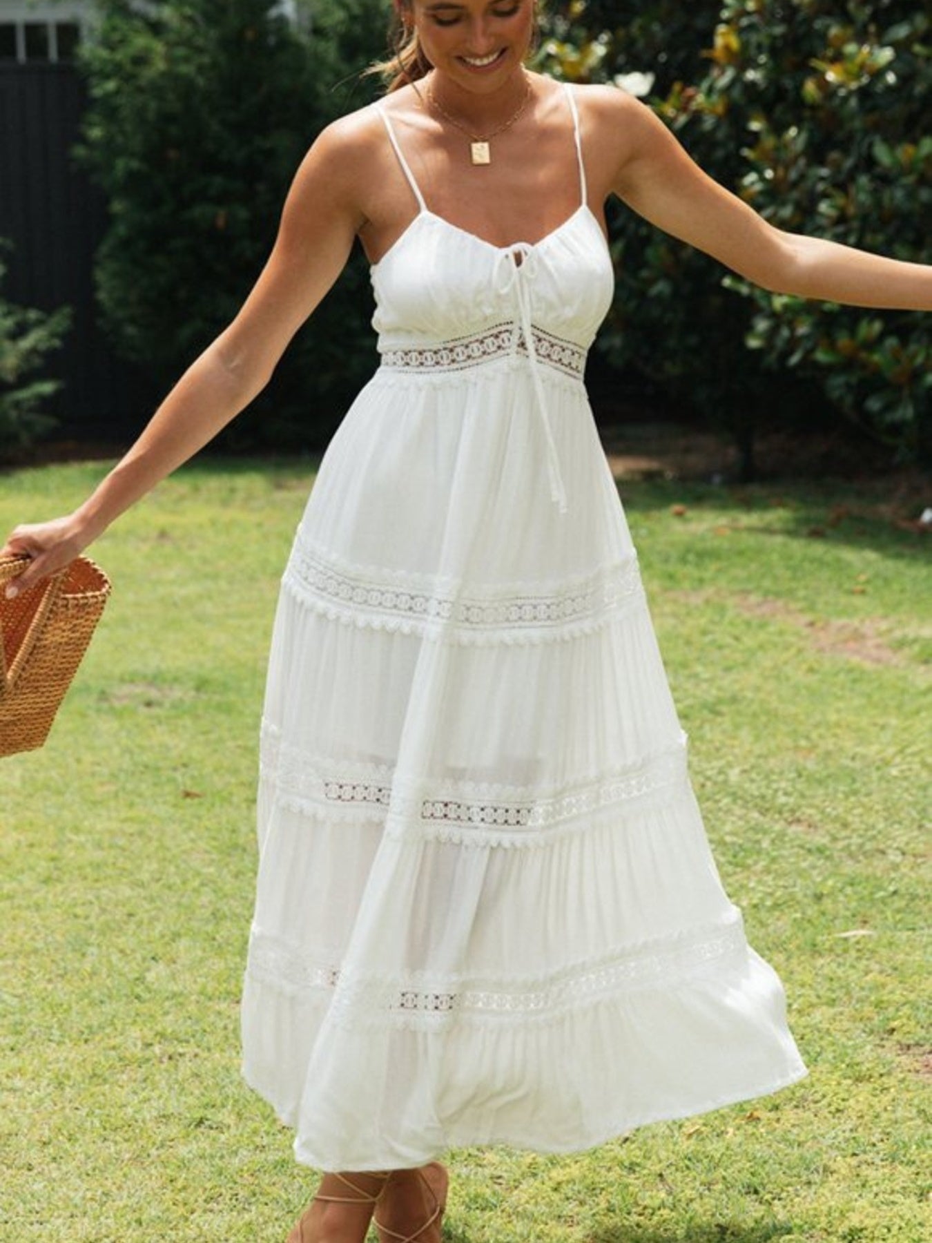 White lace trimmed tiered midi dress with spaghetti straps and tie front.