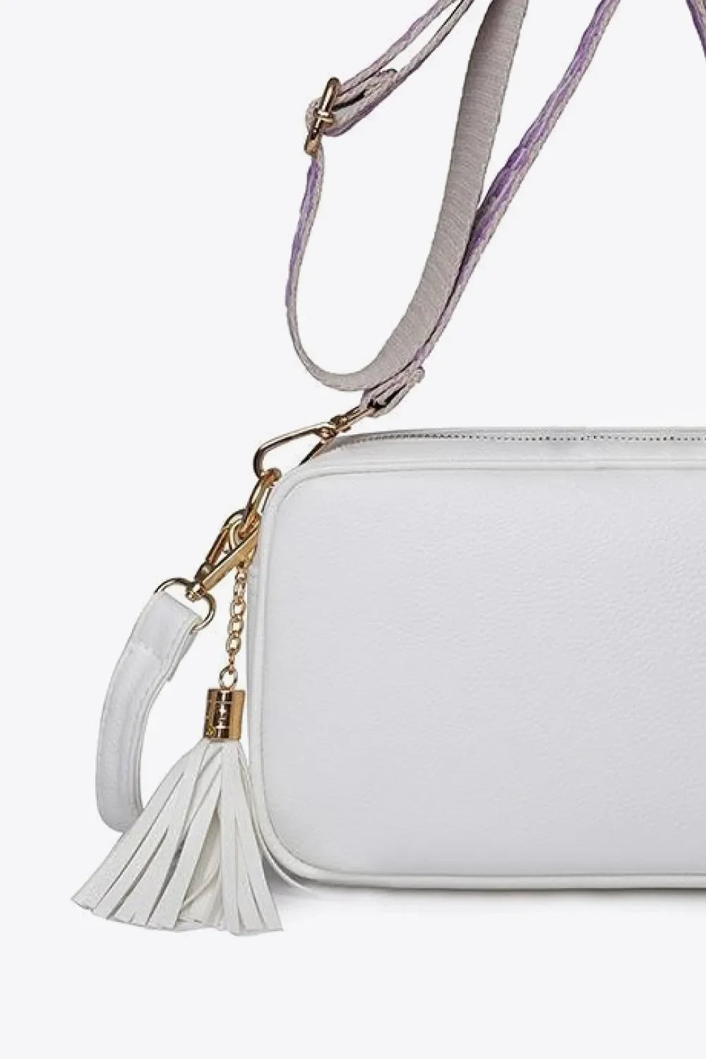 White textured crossbody bag with tassel detail and adjustable strap