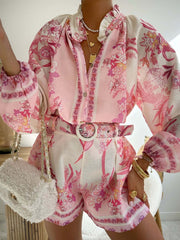 Pink floral print button-up shirt and shorts set with ruffled collar and balloon sleeves.