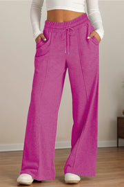 Seamed palazzo lounge trousers in fuchsia pink with drawstring waist and pockets.