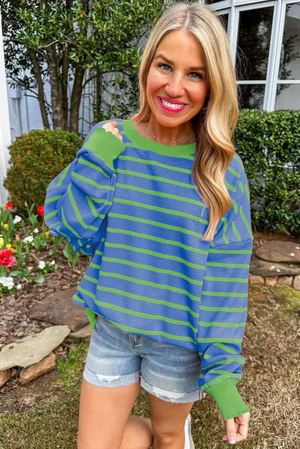 Waffle knit top with blue and green stripes, crew neck, and contrast green cuffs.