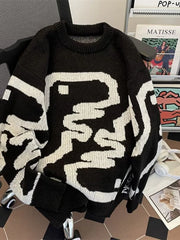 Black oversized sweater with abstract white pattern, ribbed hem and crew neck.