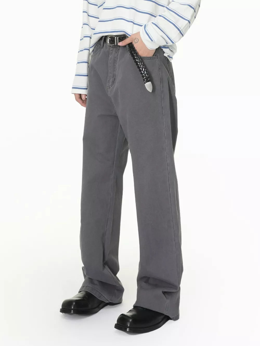 Men's relaxed fit grey cotton jeans with button closure and black belt.