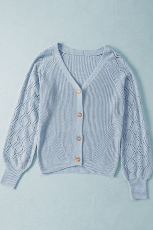 Light blue diamond-cut sleeve knit cardigan with V-neck and button front.
