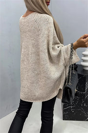 Relaxed knit sweater in Khaki with cape sleeves and a relaxed fit.
