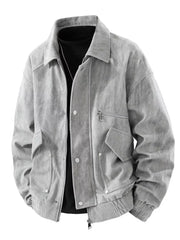 Grey corduroy trucker jacket with buttoned pockets and zip closure.