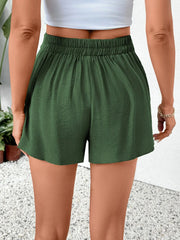Dark green high-waisted shorts with elastic waist and button detail.