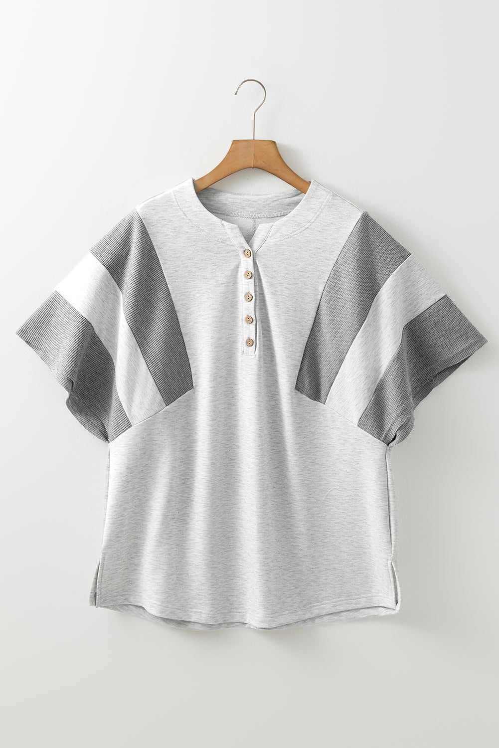 Gray colorblock waffle knit henley top with button detail and short sleeves.