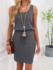 Sleeveless gray waffle-knit drawstring dress with a tasseled tie.