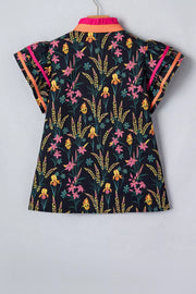 Vibrant floral print cotton blouse with contrast trim on collar and flutter sleeves.