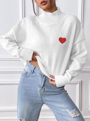 White cropped turtleneck knit sweater with embroidered red heart detail