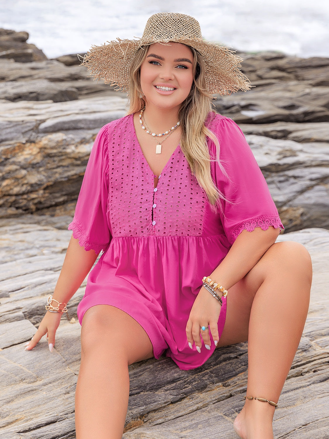 Hot pink eyelet yoke romper with flutter sleeves and lace trim.