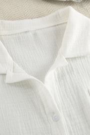White gauze pajama top with collared neckline and button detail