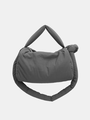 Dark gray padded knot shoulder bag with a zipper closure and puffy straps.