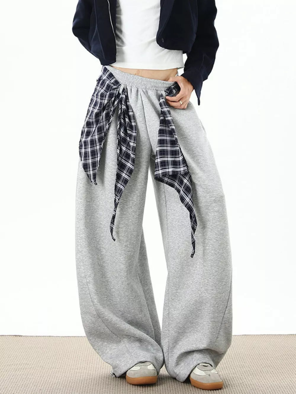 Grey relaxed fit wide-leg sweatpants with plaid tie detail.