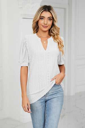 White perforated puff sleeve blouse with keyhole neckline and casual cut.