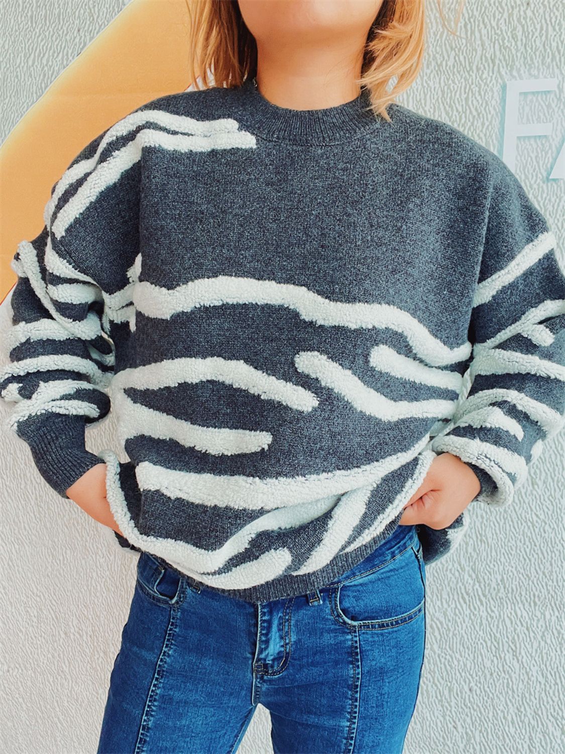 Textured stripe knit crewneck sweater in dark gray with white fuzzy stripes.