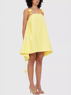 Yellow A-line mini dress with floral applique straps and hem detail.