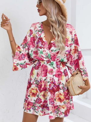 Floral mini dress with V-neck, flutter sleeves, and tiered ruffle hem.