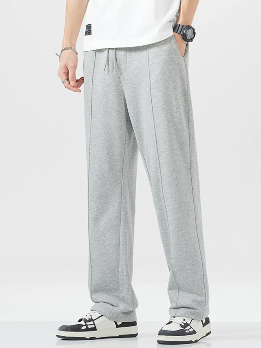 Grey sweatpants with drawstring waist and vertical seam detail.