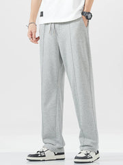 Grey sweatpants with drawstring waist and vertical seam detail.