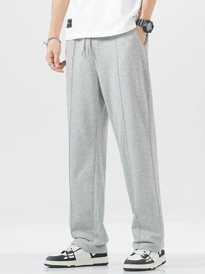 Grey sweatpants with drawstring waist and vertical seam detail.