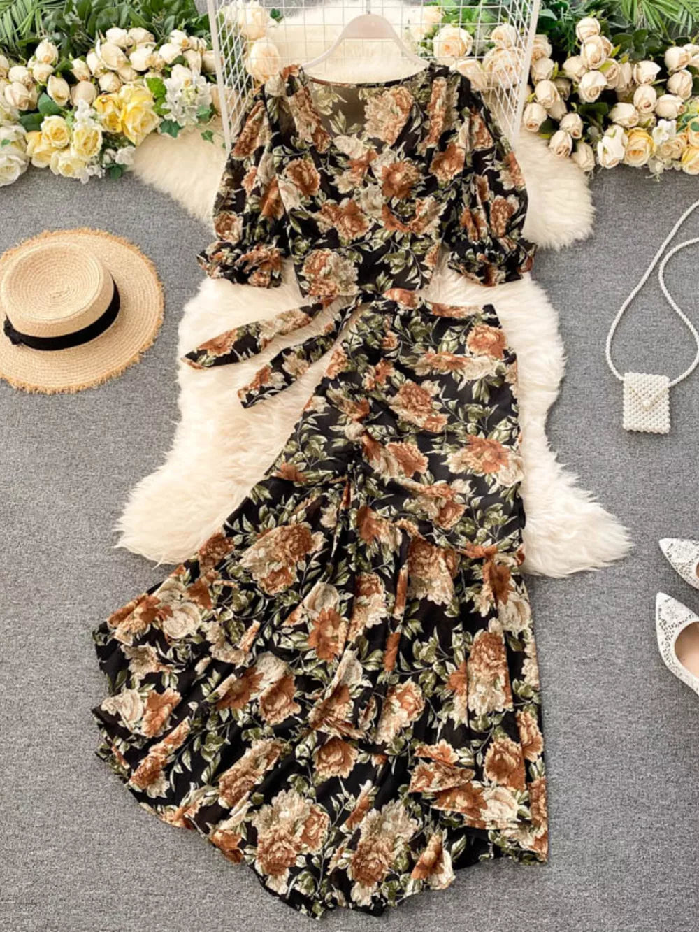 Chic floral two-piece crop set with tie waist and ruffled skirt.