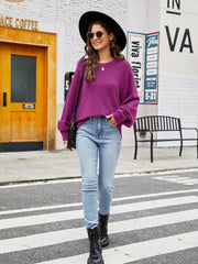 Fuchsia acrylic crewneck sweater with balloon sleeves, cuffed at the wrist.