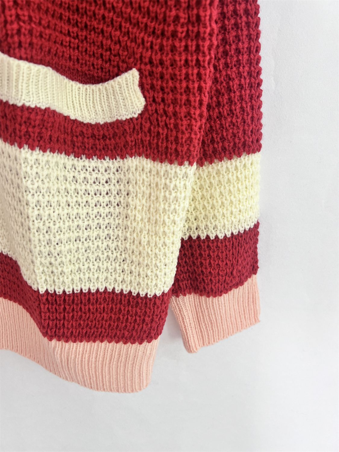 Textured knit cardigan with varsity stripes in scarlet, cream, and pink.
