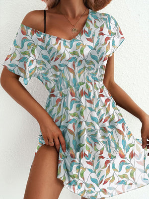 Vibrant leaf print mini dress with slit and V-neck, elastic waist, short sleeves.