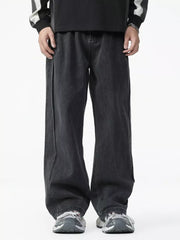 Men's dark wash cotton wide-leg jeans with elastic waist and contrast stitching.