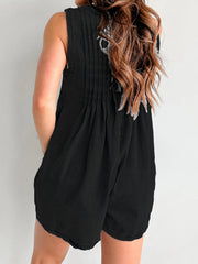 Black denim playsuit with pleated back detail and A-line shorts.