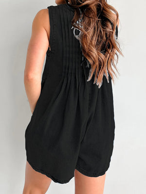 Black denim playsuit with pleated back detail and A-line shorts.