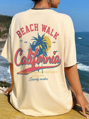 Tan oversized graphic tee with California beach scene and text, crew neck, short sleeves.