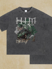 Dark gray acid wash graphic tee with "The Drip" text and distressed artwork.