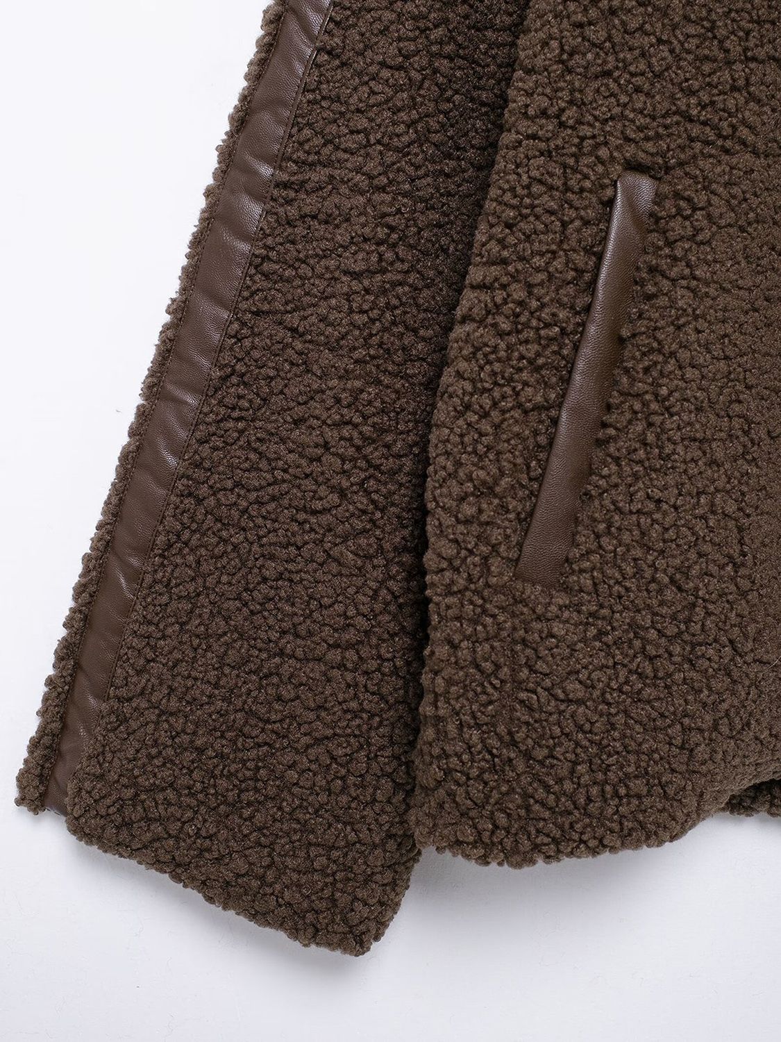 Dark brown teddy fleece zip-up jacket with contrast faux leather piping and pocket trim.
