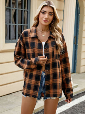 Checkered long sleeve collared top in brown and black plaid with buttoned pockets.