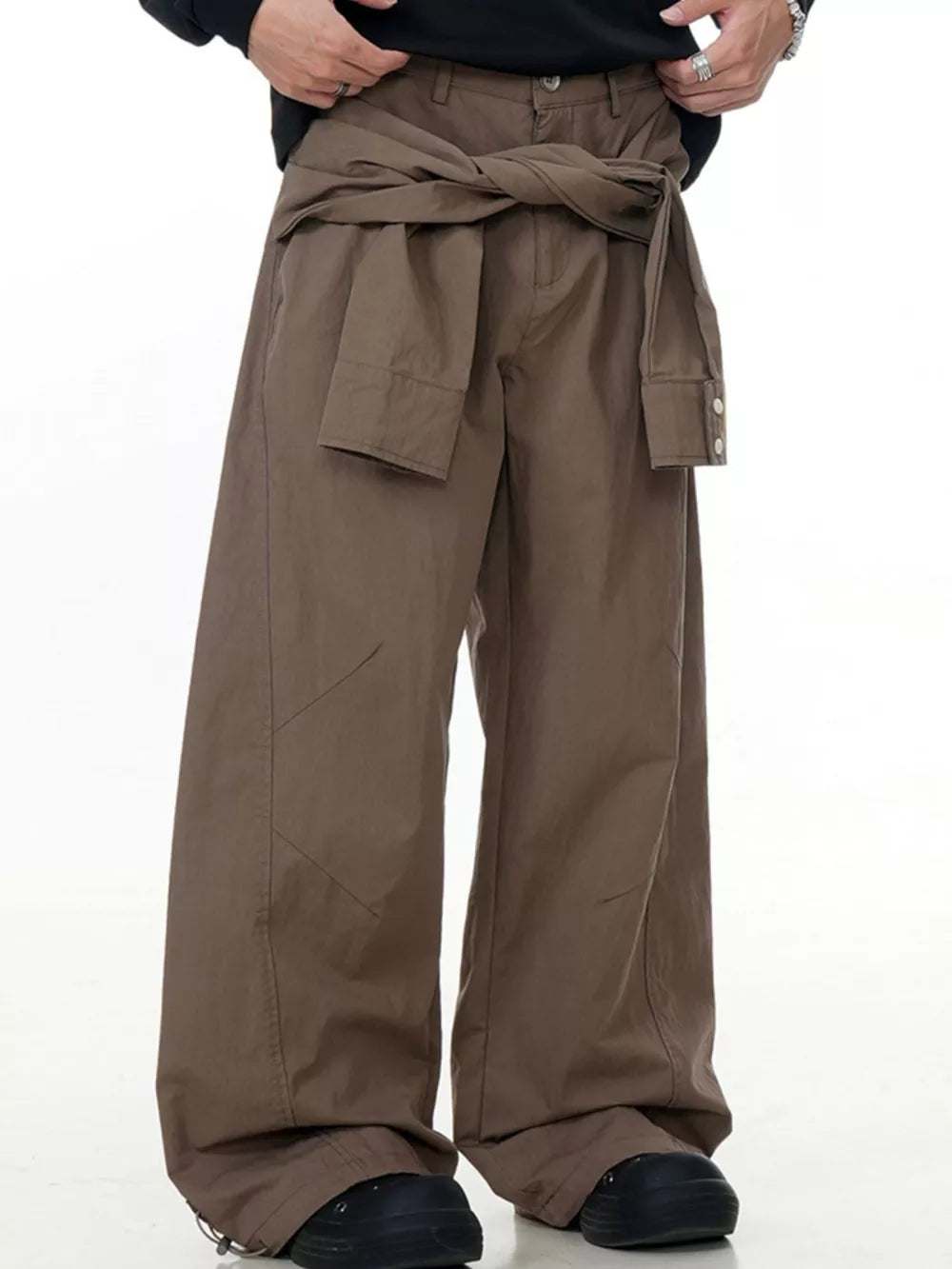 Brown wide-legged cargo pants with a tie waist and buttoned cuffs.