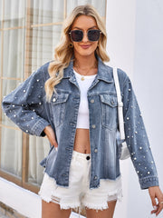 Dusty blue denim jacket with pearl embellishments and frayed hem.