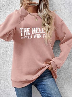 Blush pink crewneck sweatshirt with white graphic text and floral detail.