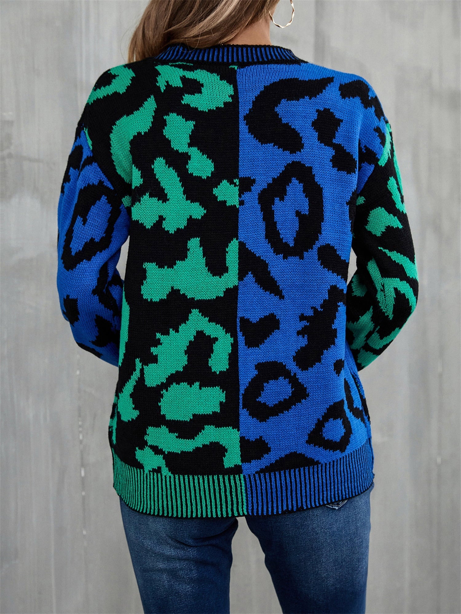 Split leopard knit sweater in blue/green with statement sleeves and crew neck.