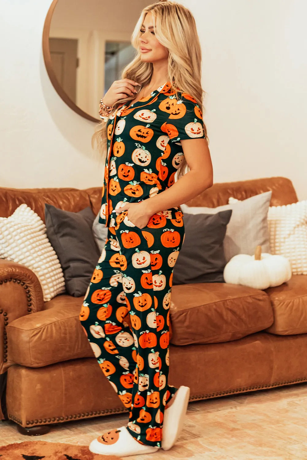 Pumpkin Patch Pajama Set with short sleeves and pants, featuring a dark green base with an all-over jack-o'-lantern print.
