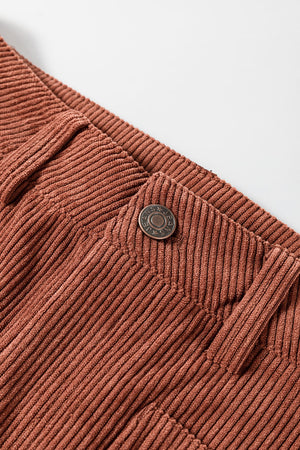 Brown corduroy flared leg trousers with a button closure detail.
