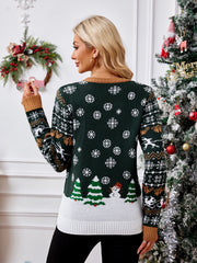 Green acrylic knit sweater with snowflakes, trees, and snowman graphic.