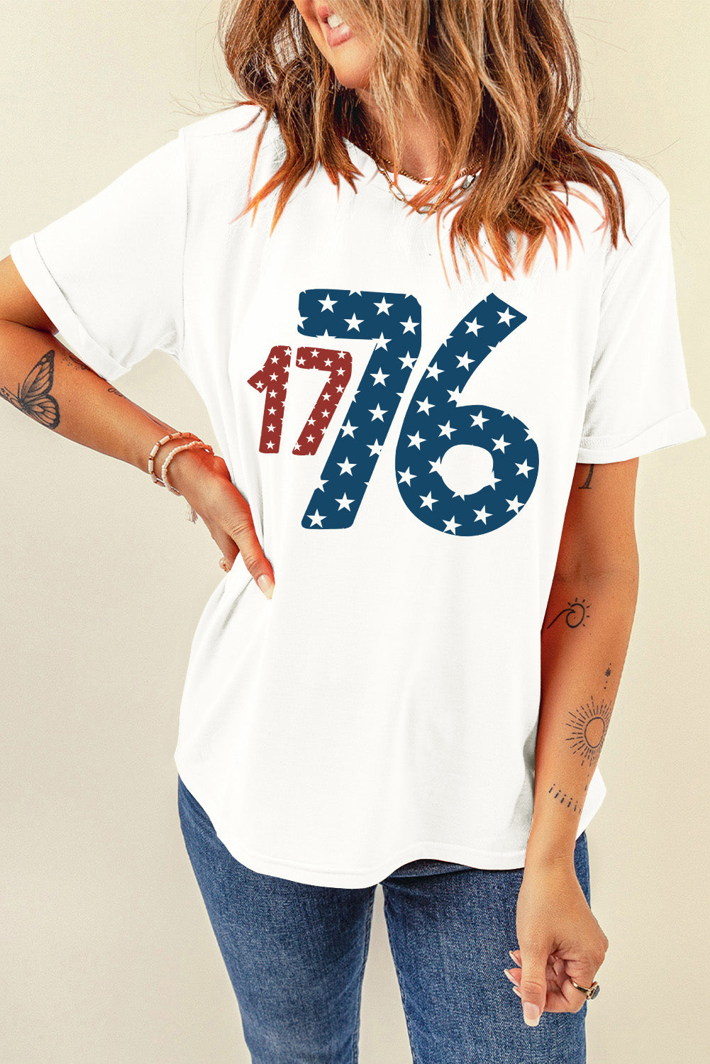 White graphic tee with patriotic 1776 star print, crew neck, short sleeves.