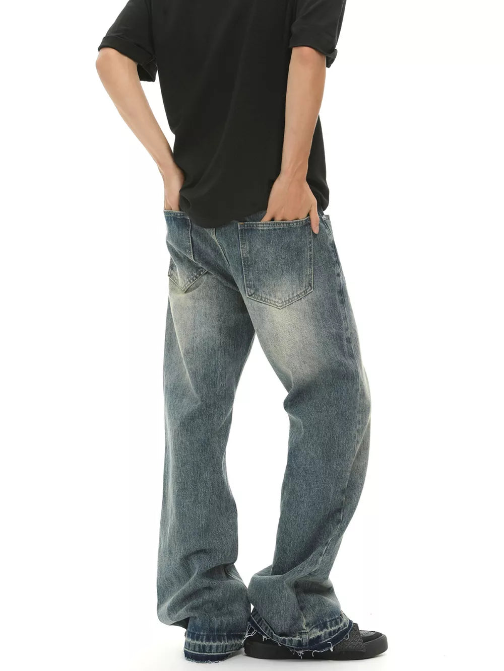 Men's loose fit vintage wash blue denim jeans with frayed hems.