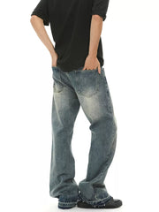 Men's loose fit vintage wash blue denim jeans with frayed hems.