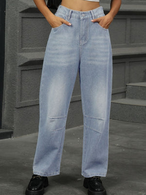 Relaxed light wash denim trousers with patchwork knee details and a straight leg cut.
